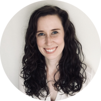 Circular headshot portrait of a smiling woman with long dark curly hair