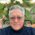 Headshot of David Kyle in a navy blue turtleneck