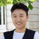 Headshot of Yao Lu in a white t-shirt and black vest 